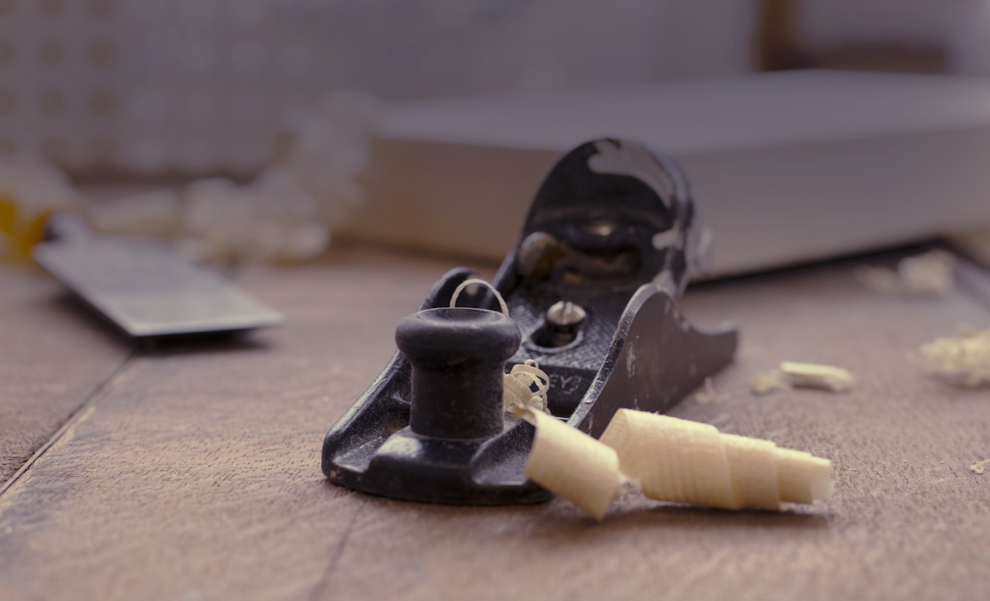 Wood being planed by hand